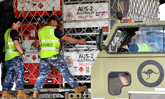 Australian Air Force workers loading pellets of resources onto a plane for the Turkiye earthquake victims.