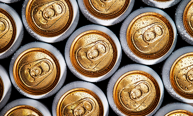 Cans of cold beer stacked next to each other