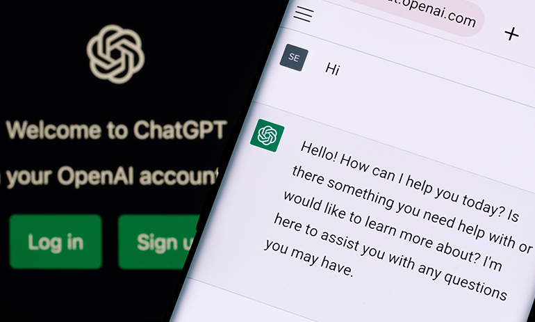 Image depicting the use of ChatGPT technology with a phone showing the chatbot and the logo in the background.