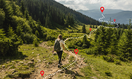 young woman hiking up a mountain to reach peak