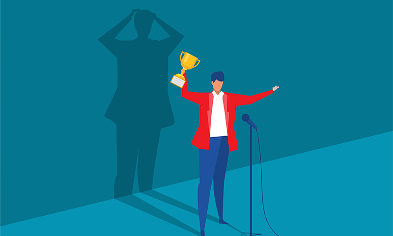 Woman in a suit holding a trophy while her shadow reflects someone stressed and worried, symbolising Imposter Syndrome.|Workers on wooden blocks connected together to symbolise a large organisation.