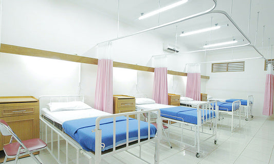 A series of hospital beds in a hospital room.