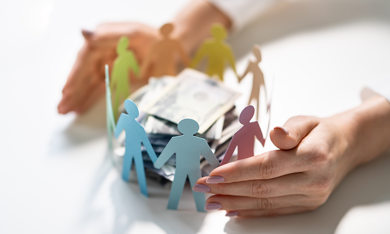 Cutout paper human figures circling a stack of money.