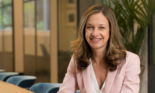 Headshot of Rosemary Conn smiling in a pink blazer.