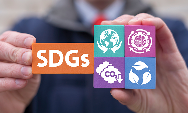 Man holding sustainable development building blocks with pictures of sustainability.