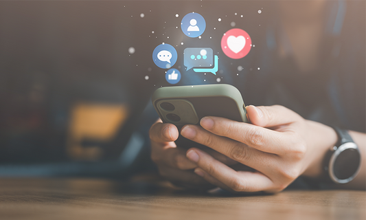 Person holding phone with social media icons