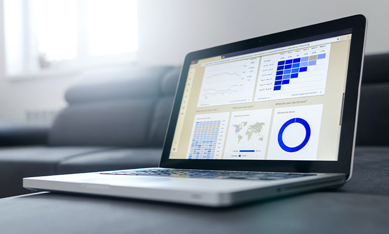 A laptop computer, with graphs on the screen