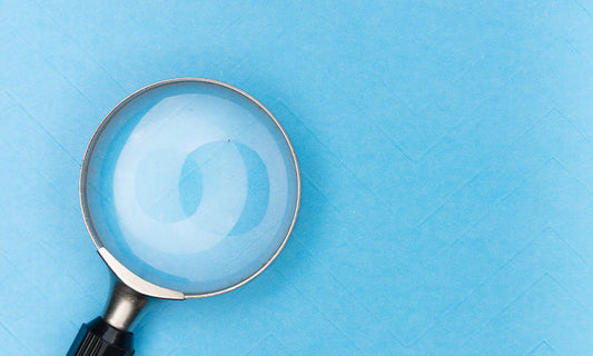 A magnifying glass on a blue background