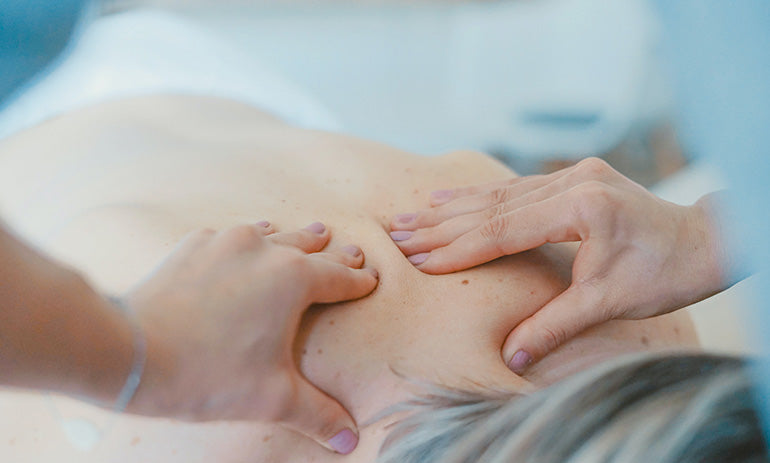 A chiropractor works on a person's back.