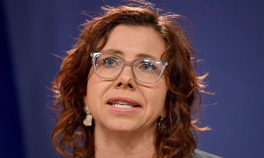 Amanda Rishworth, a woman with curly dark hair and glasses, is speaking. We see only her face.