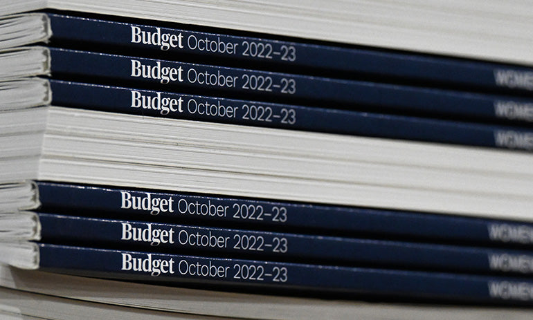 A pile of books, some with their spines pointing to the camera, saying 'Budget October 2022-23'|A pile of books, some with their spines pointing to the camera, saying 'Budget October 2022-23'