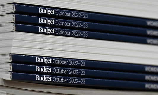 A pile of books, some with their spines pointing to the camera, saying 'Budget October 2022-23'|A pile of books, some with their spines pointing to the camera, saying 'Budget October 2022-23'