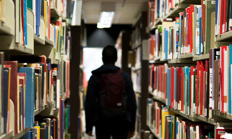 A person walks through a library