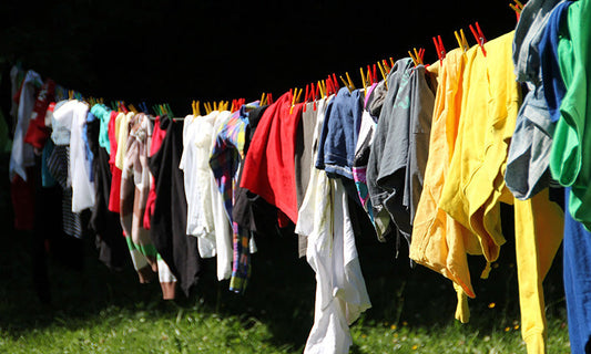 a line of colourful clothes on a washing line|Colourful clothes on a washing line