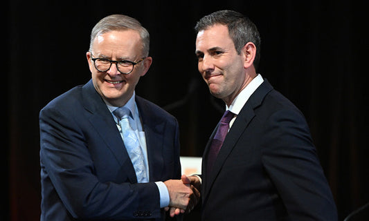 Anthony Albanese and Jim Chalmers, two white men in dark suits, shake hands and smile at the camera.|jobs-and-skills-