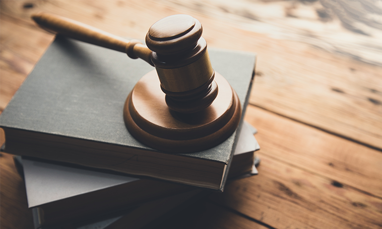 legal hammer on stack of books