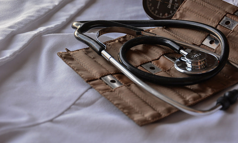 A brown instrument wallet with a stethoscope lying on it.