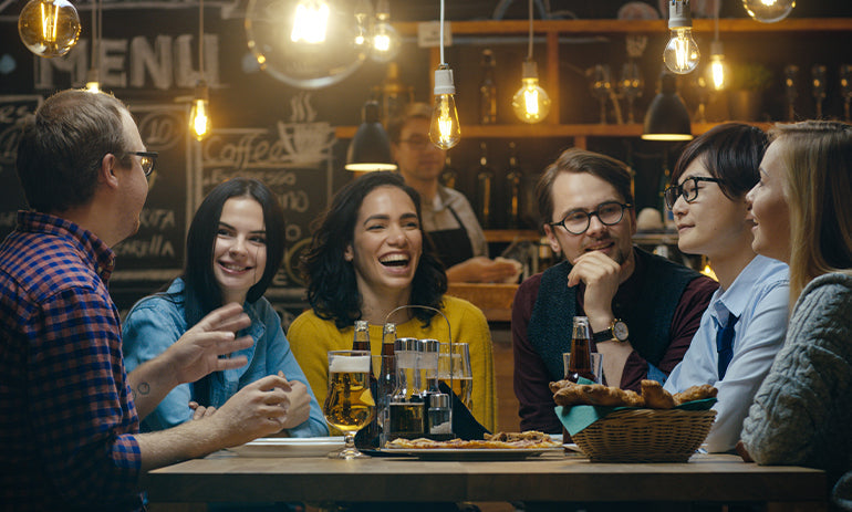 group of millennials sitting in a restaurant
