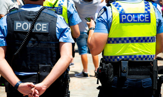 two police with their backs to the camera
