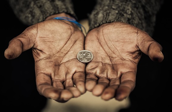 Upturned hands containing a solitary coin.