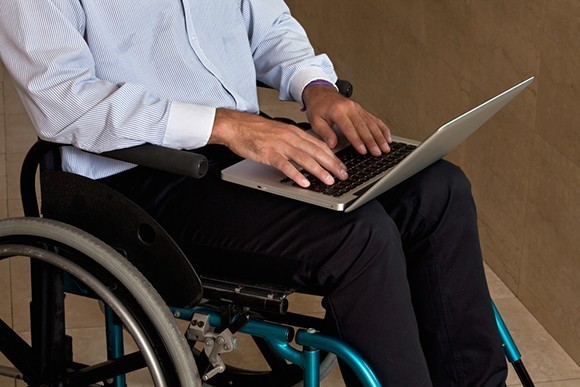 Man in wheelchair on laptop