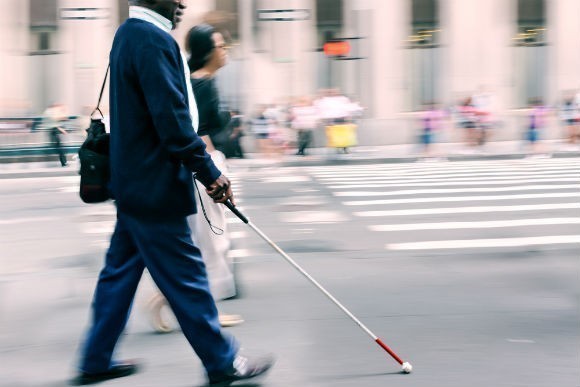 Man with white cane walking RS