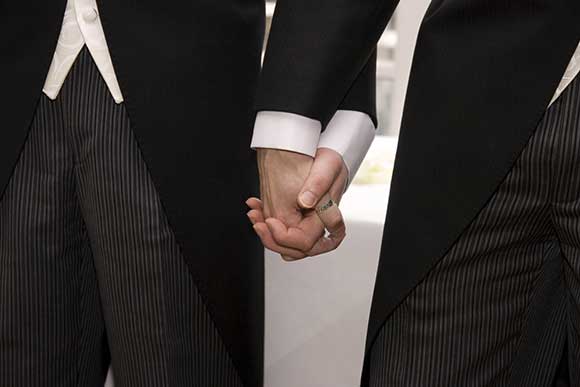 Gay couple holding hands getting married