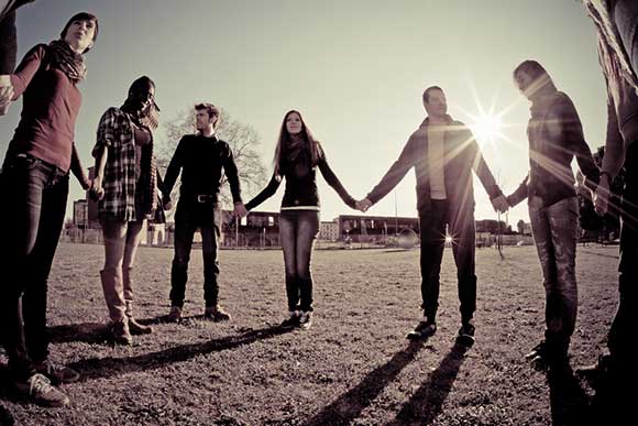 Young people holding hands