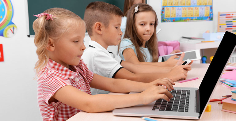 Pupils using laptops in the classroom