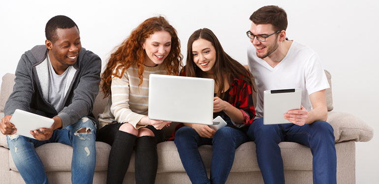 Group of young people looking at laptop