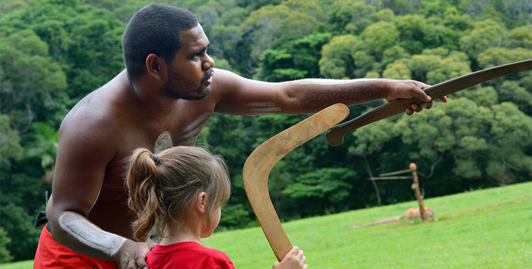 Aboriginal man teaches child in traditional ways