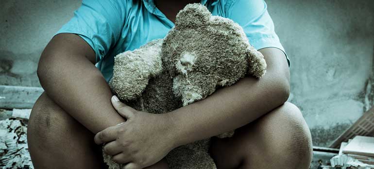 Child holding teddy