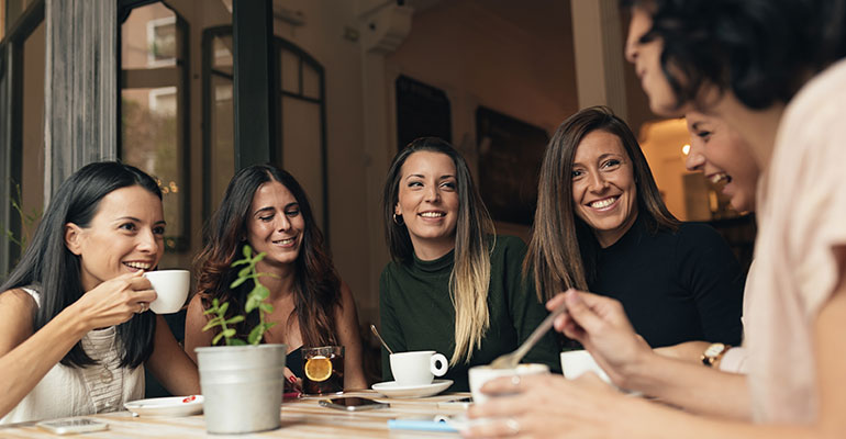 Group of women talking and drinking coffee