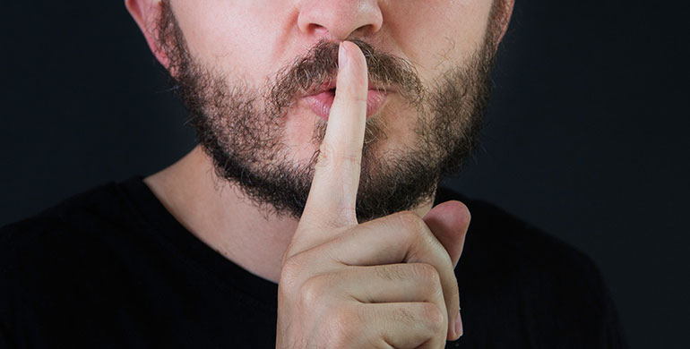 Man with finger on lips