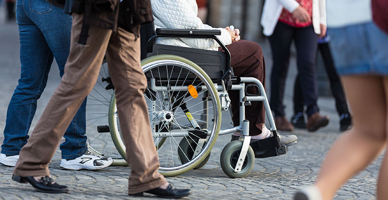 Person in a wheelchair in a crowded street