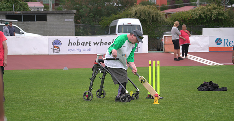 man with disability playing cricket