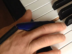person playing piano with prosthetic finger