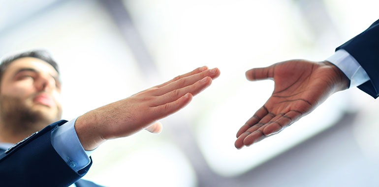 business people reaching to shake hands