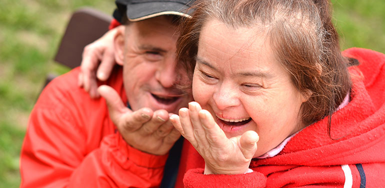 couple with disability blowing a kiss