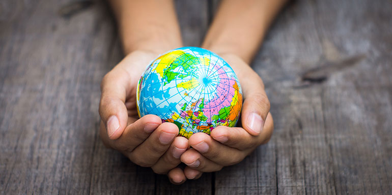 hands holding a globe
