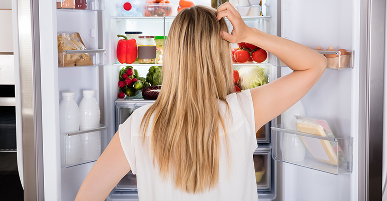 Woman in front of fridge