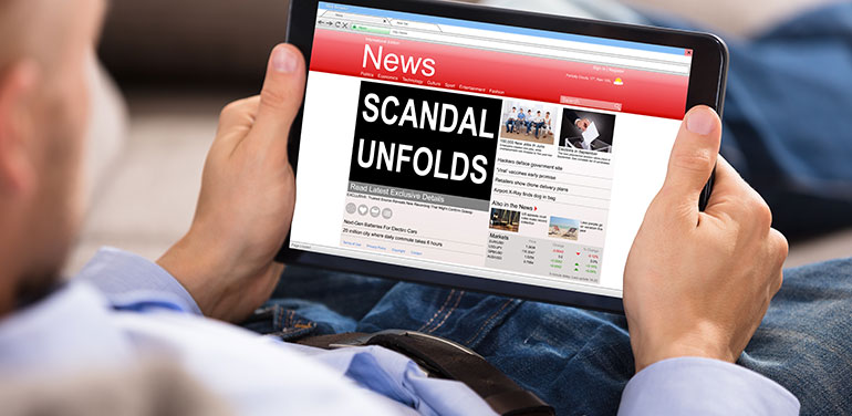 Person looking at scandal in the news