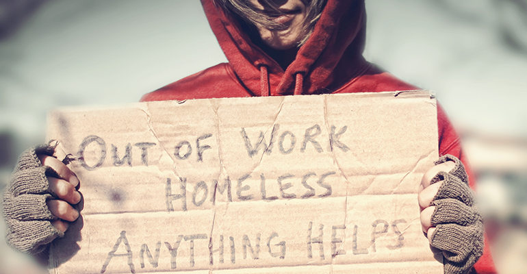 homeless woman holding sign