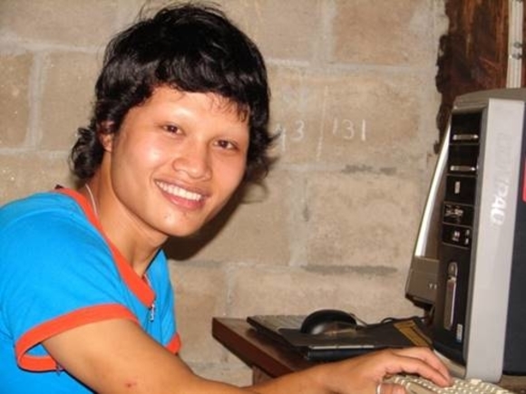 Young refugee working on computer