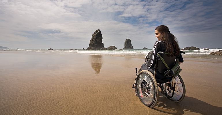 woman with wheelchair on the beach