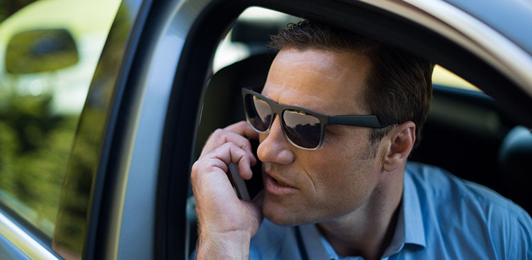 Banker in car on phone