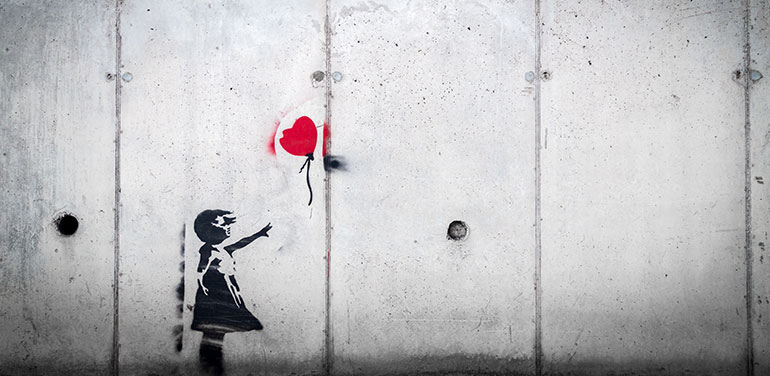 Banksy image of girl reaching out for balloon