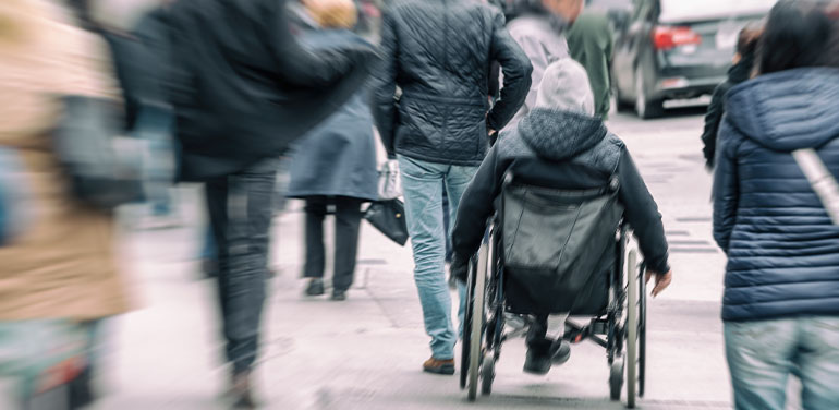 Person in wheelchair in crowded street