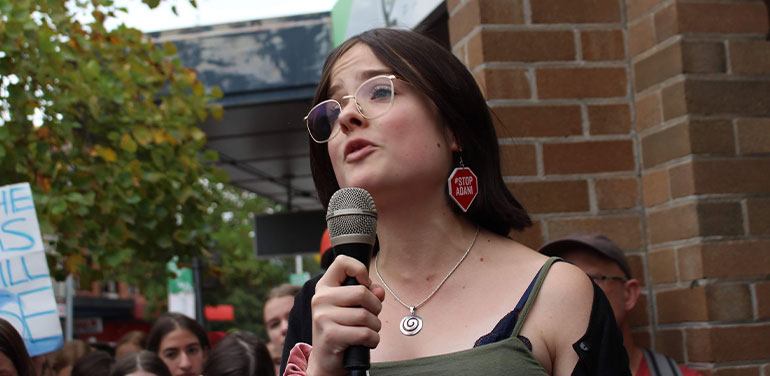 Daisy Jeffrey speaking at a march