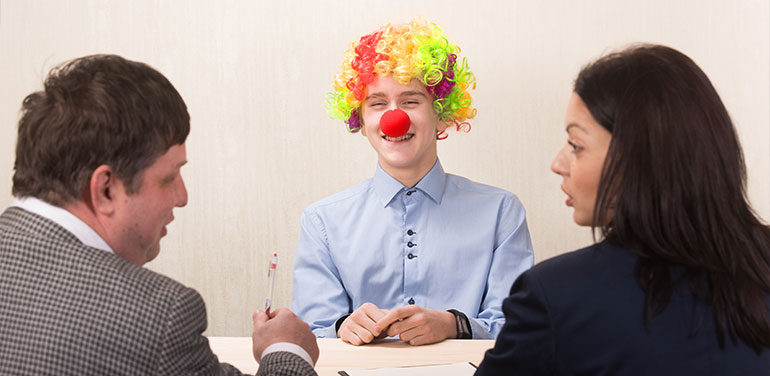 Man dressed as a clown in a job interview